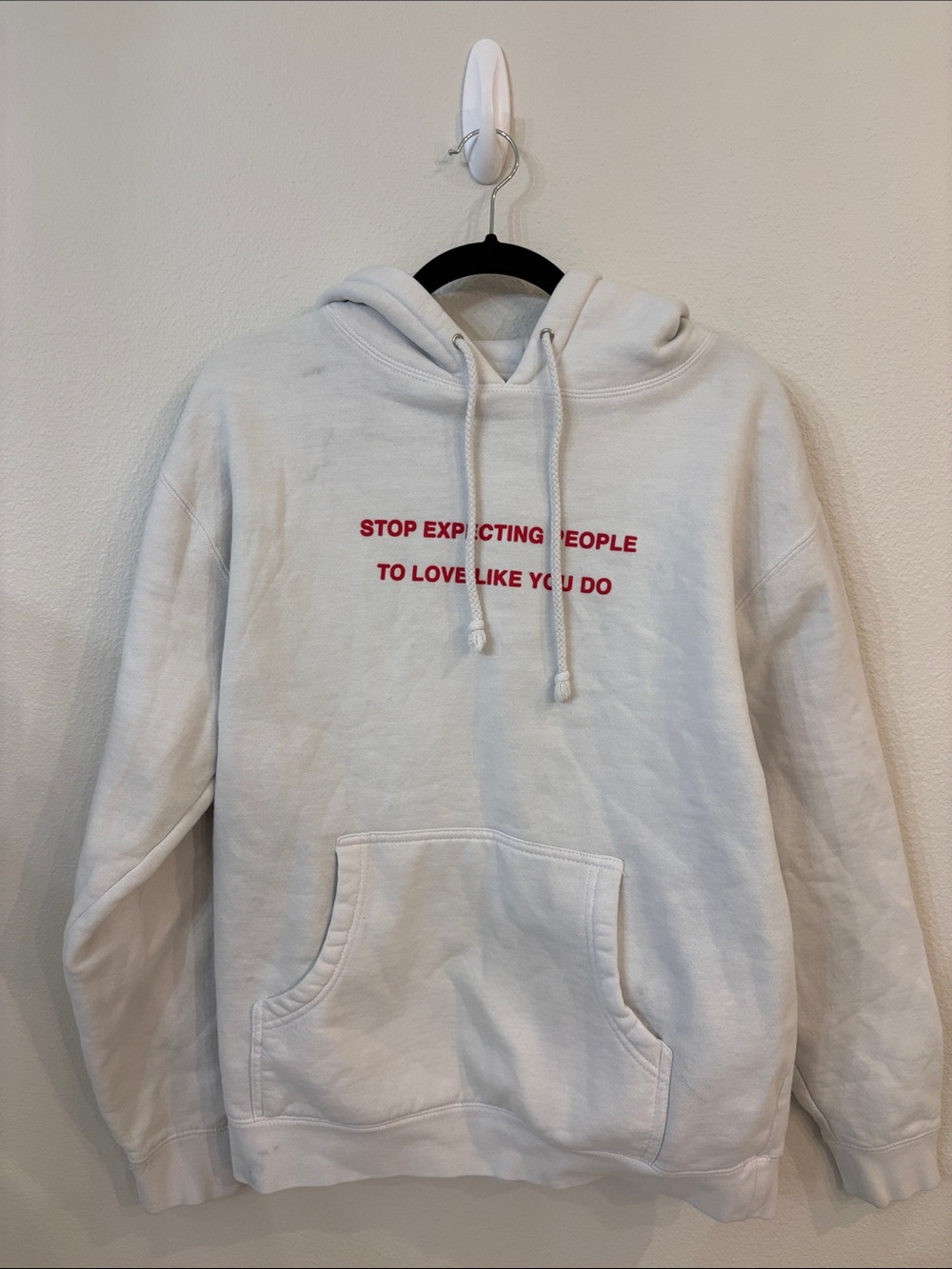 We’re Not Really Strangers White Hoodie Sweatshirt with Red Text